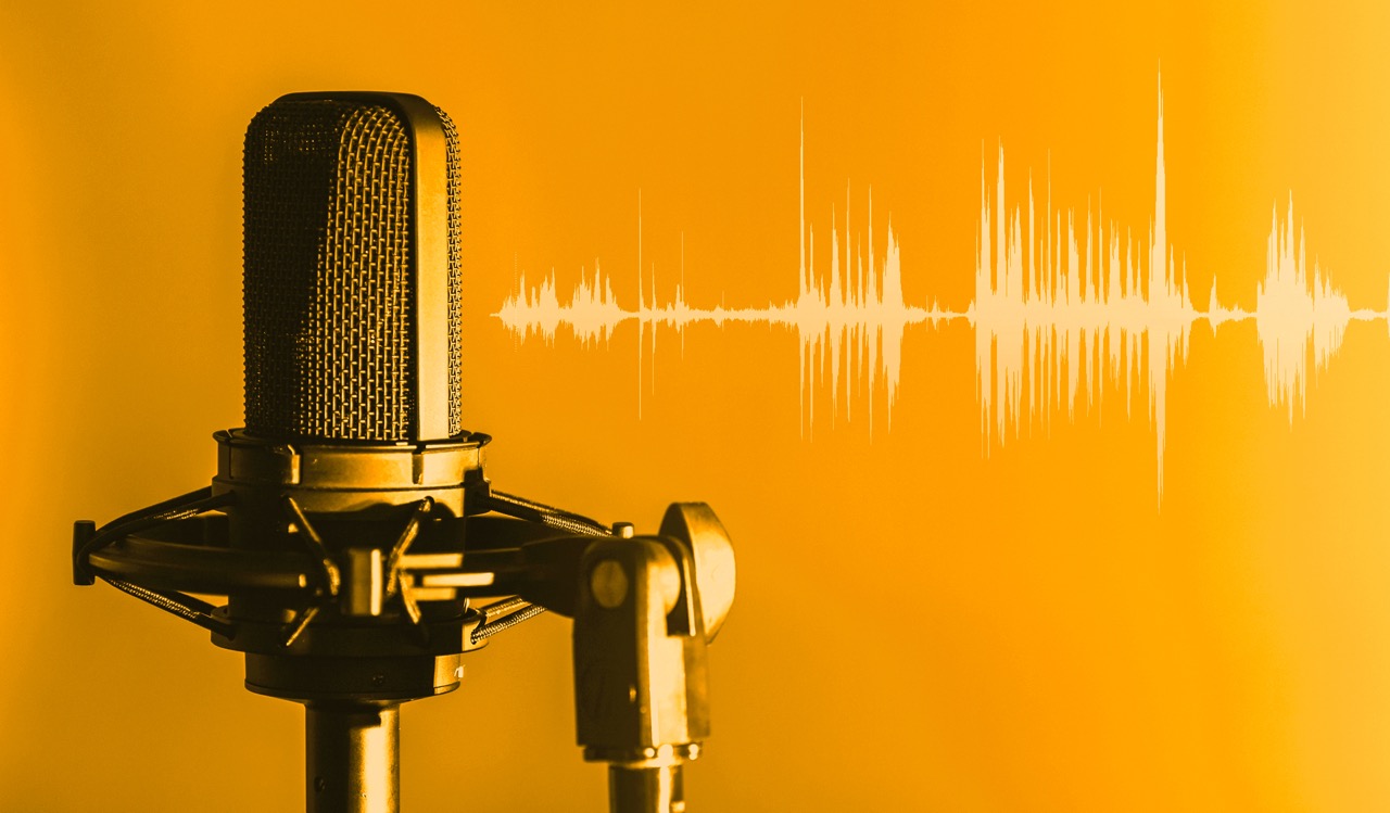A yellow graphic of a broadcasting microphone with white sound waves in the background